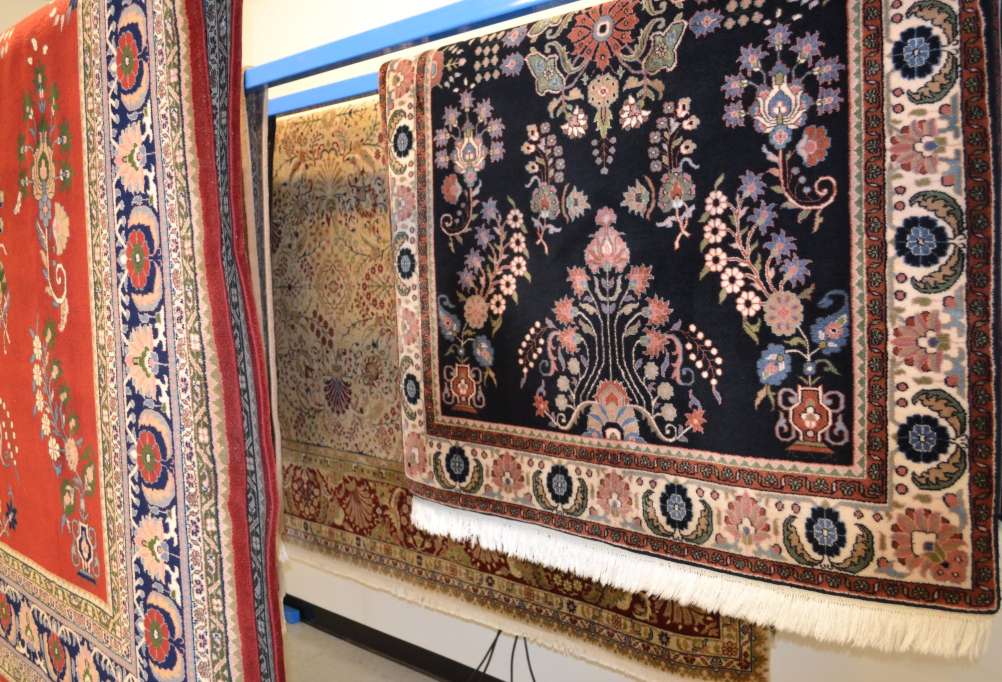 Freshly washed Oriental rugs hanging to dry in a controlled environment