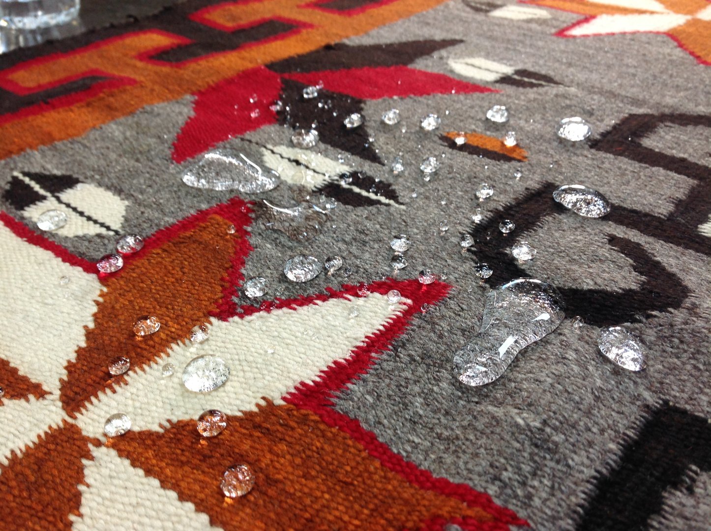 Liquid beading on the surface of a rug treated with fiber protector