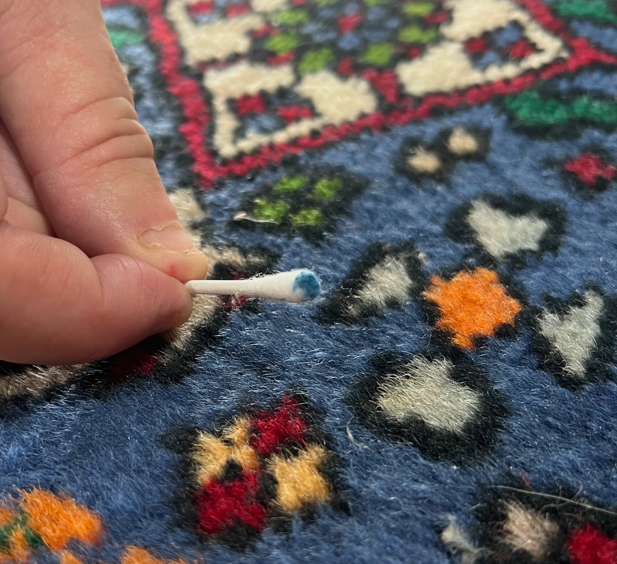 Dye bleeding on a blue and red rug